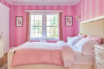 a pink bedroom with a large bed and a window at Luxe Homestay in Hollywood - by The Grove & Walk of Fame in Los Angeles