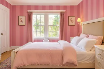 a pink bedroom with a large bed and a window at Central Hollywood Homestay Getaway in Los Angeles