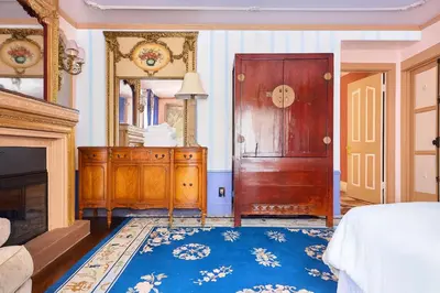 a bedroom with a wooden door and a mirror at Central Hollywood Homestay Getaway in Los Angeles