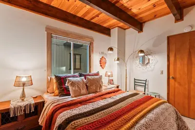 a bedroom with a large bed and a window at Retro Retreat, BBQ, Patio with Outdoor Seating! in Lake Arrowhead