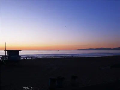 a sunset on a beach with the ocean in the background at Amazing location, Unique Oceanfront Beach House! in Manhattan Beach