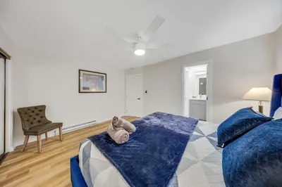 a bedroom with a blue bed and a chair at Oneluxstay 3BR Home Near the Beach in Redondo Beach