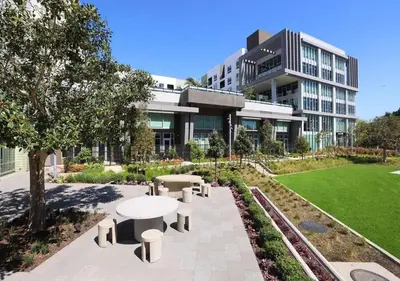 a building with a table and benches in front of it at Urban Chic Home 10 Min from Disneyland With Pool & GYM in Santa Ana