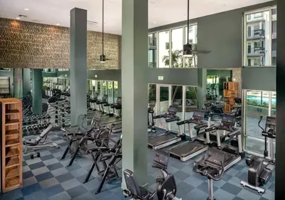 a gym with a lot of treadmills and ellipticals at Urban Chic Home 10 Min from Disneyland With Pool & GYM in Santa Ana