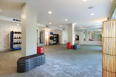 a large room with white walls and a gym with red drums at Pacific Paradise 10 Min from Disneyland With Pool & GYM in Santa Ana