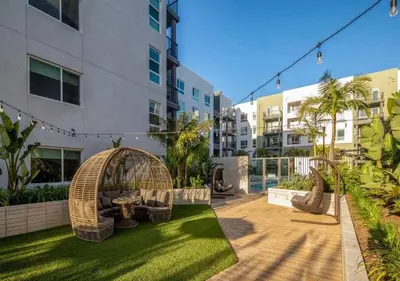 a courtyard with a gazebo and chairs in a building at Premium Stay 10 Min From Disneyland With Pool & GYM in Santa Ana