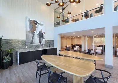 a lobby with two tables and chairs in a building at Premium Stay 10 Min From Disneyland With Pool & GYM in Santa Ana