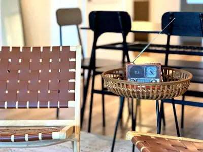 a basket with a radio in it on a table with chairs at Luxury Haven 10 Min From Disneyland With Pool & GYM in Santa Ana