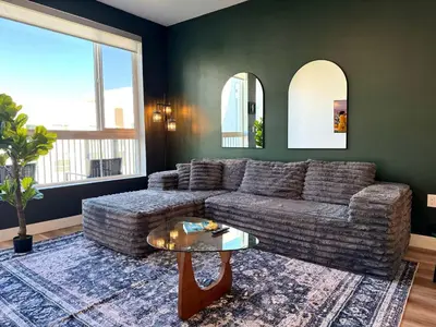 a living room with a couch and a table at Elegant Escape 10 Min from Disneyland With Pool & GYM in Santa Ana
