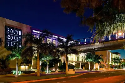 a train on a bridge over a street at night at Elegant Escape 10 Min from Disneyland With Pool & GYM in Santa Ana