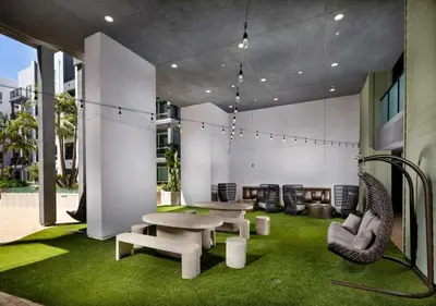 a room with two tables and chairs and grass at Modern Retreat 10 Min from Disneyland With Pool & Gym in Santa Ana