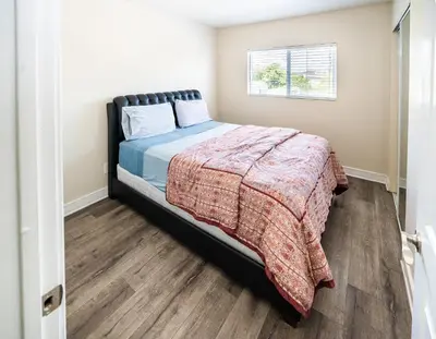 a bedroom with a bed and a window at Spacious 5BR 3BA Home with Free Parking and WiFi 10 Minutes to Downtown LA Perfect for Large Groups in Los Angeles