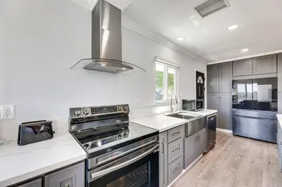 a kitchen with white counters and a stove top oven at Enchanting 4-bedroom house with panoramic view in Pasadena in Los Angeles