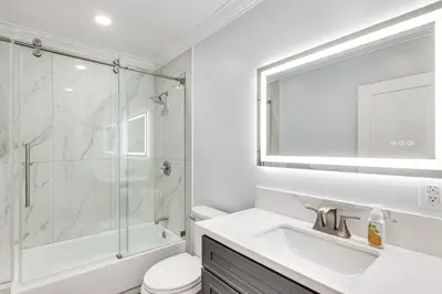 a white bathroom with a shower and a sink at Enchanting 4-bedroom house with panoramic view in Pasadena in Los Angeles
