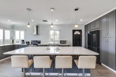a kitchen with a large island with chairs in it at Enchanting 4-bedroom house with panoramic view in Pasadena in Los Angeles