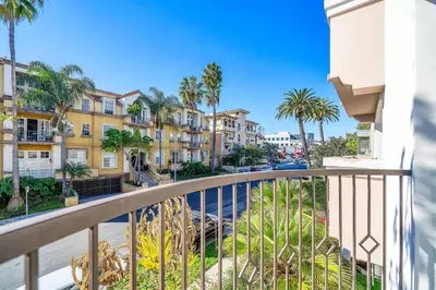 a balcony with palm trees and condos at Amazing & Spacious in Heart of Santa Monica- Easy Access to ALL Tourist attractions in Los Angeles