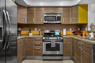 a kitchen with a stove and a microwave at Amazing Spacious Unit in Heart of LA- Melrose district in Los Angeles