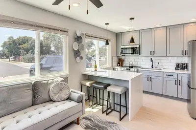 a kitchen with a couch and a kitchen with a counter at Newly Updated! Commuter-Friendly Anaheim Home in Anaheim