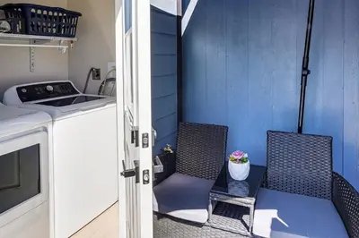 a small kitchen with two chairs and a sink at Newly Updated! Commuter-Friendly Anaheim Home in Anaheim