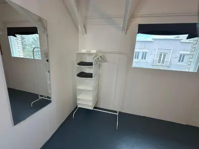 a room with white walls and a window and shelves at The Art Nook Private Rooms on Hollywood Blvd in Los Angeles
