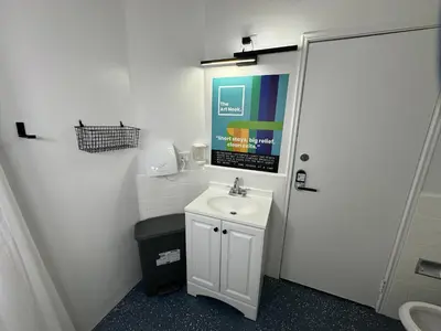 a bathroom with a white sink and a toilet at The Art Nook Private Rooms on Hollywood Blvd in Los Angeles