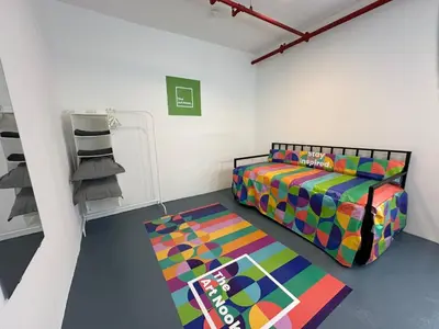a bedroom with a colorful bed and a rug at The Art Nook Private Rooms on Hollywood Blvd in Los Angeles