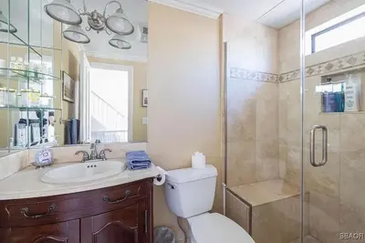 a bathroom with a shower and a toilet and a sink at Lake Forest Shores at Big Bear Lake in Big Bear Lake