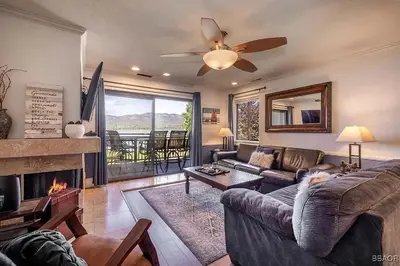 a living room with a couch and a fireplace at Lake Forest Shores at Big Bear Lake in Big Bear Lake