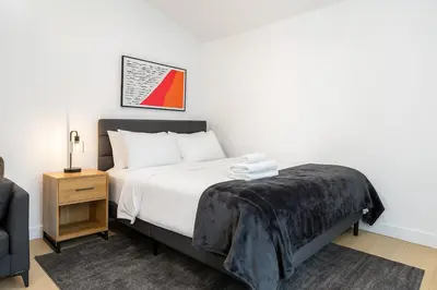 a bedroom with a bed and a chair and a table at South Pasadena Studio Spa Escape in South Pasadena