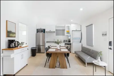 a kitchen and living room with a table and a couch at South Pasadena Studio Spa Escape in South Pasadena