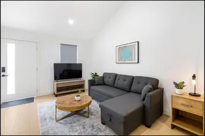 a living room with a couch and a tv at South Pasadena Studio Spa Escape in South Pasadena