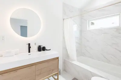 a white bathroom with a sink and a mirror at South Pasadena Studio Spa Escape in South Pasadena