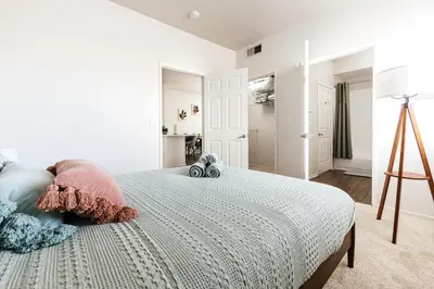 a white bedroom with a large bed with pillows at Pearl 2B apartment in Marina with parking, Pool and Gym in Los Angeles