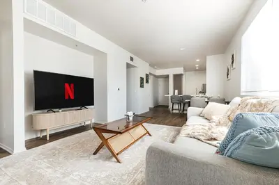 a living room with a couch and a tv at Pearl 2B apartment in Marina with parking, Pool and Gym in Los Angeles