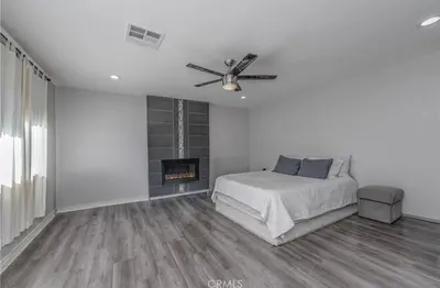 a white bedroom with a bed and a fireplace at \u8fd1ONT\u673a\u573a Chaffey Claremont\u5b66\u9662 Ontario Outlets 3Br2BA in Rancho Cucamonga