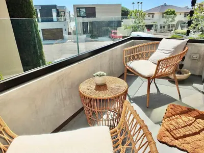 a balcony with two chairs and a table and a window at Naples Luxury Retreat - 3 BDR Stay for 6 w Rooftop Patio in Long Beach