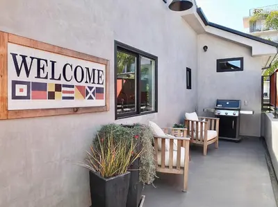 a welcome sign on the side of a building at Naples Luxury Retreat - 3 BDR Stay for 6 w Rooftop Patio in Long Beach