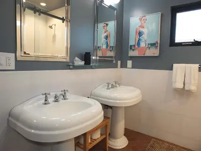 a bathroom with a sink and a mirror at Naples Luxury Retreat - 2 BDR Walk to Beach Dining & Shops in Long Beach