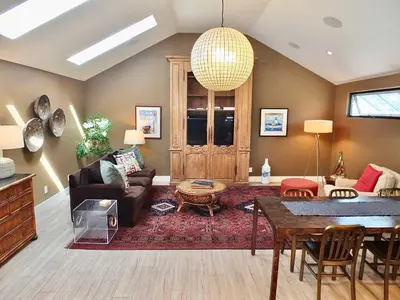 a living room with a couch and a table at Naples Luxury Retreat - 2 BDR Walk to Beach Dining & Shops in Long Beach