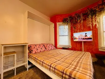a bedroom with a bed and a tv on the wall at Beautiful Venice Beach in Los Angeles