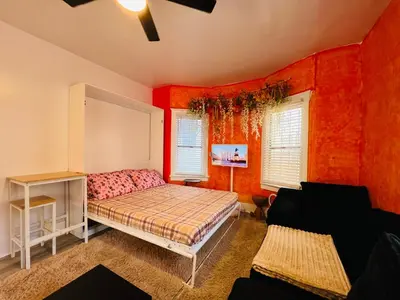 a bedroom with red walls and a bed in a room at Beautiful Venice Beach in Los Angeles
