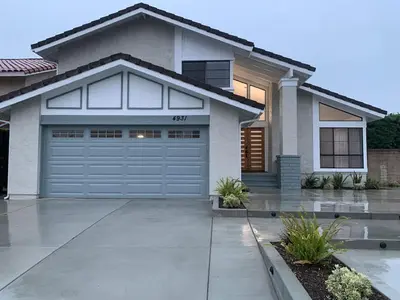 a house with a garage door in front of it at CA2 House SoCal Oasis Newly Renovated Game Room in La Palma
