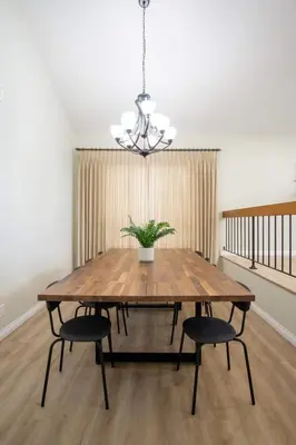 a dining room table with two chairs and a potted plant at CA2 House SoCal Oasis Newly Renovated Game Room in La Palma