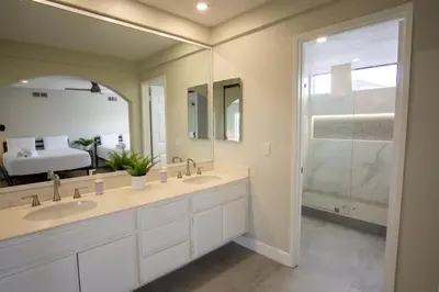 a bathroom with two sinks and a large mirror at CA2 House SoCal Oasis Newly Renovated Game Room in La Palma