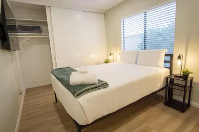 a bedroom with a large white bed and a window at CA2 House SoCal Oasis Newly Renovated Game Room in La Palma
