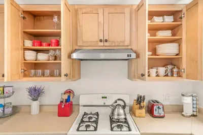 a kitchen with wooden cabinets and a stove top oven at Cornell Canyon Getaway in Agoura Hills