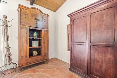 a room with a large wooden cabinet next to a door at Cornell Canyon Getaway in Agoura Hills
