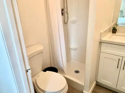 a small bathroom with a toilet and a shower at CA5 House Cozy 3BR in Azusa in Azusa