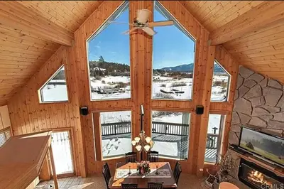 a room with a large window in a cabin at Lakefront Oasis in Fawnskin