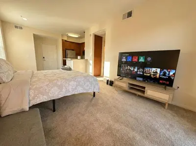 a bedroom with a large flat screen tv and a bed at Marina del Rey 1BA & 2BA Getaway - Pool - Spa - Gym in Los Angeles